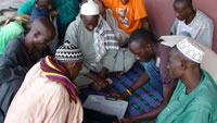 Men gathered around computer